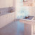 Kitchen cladding in white carrara marble, polished surface.