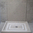 Solid shower tray in Fatima Blue limestone, honed finish.